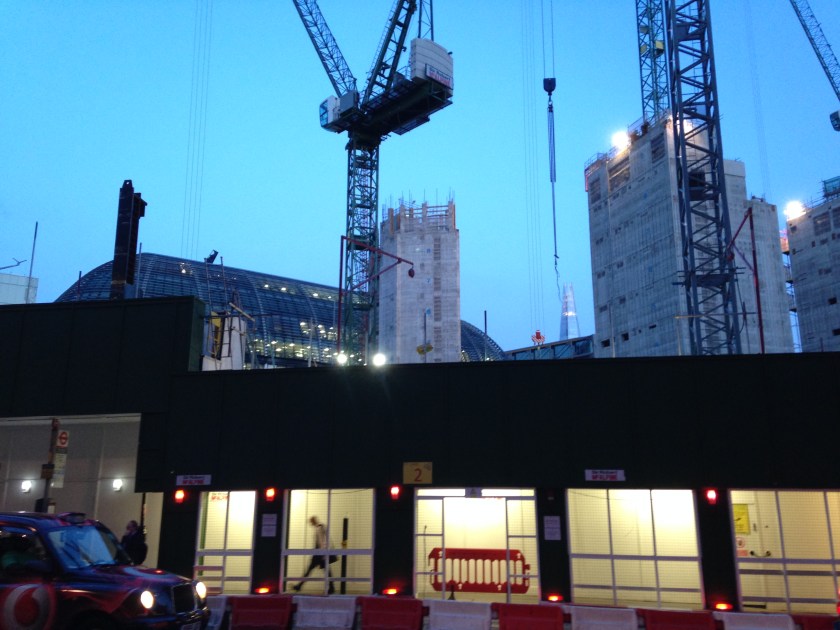 A construction site visible above temporary walkway structure