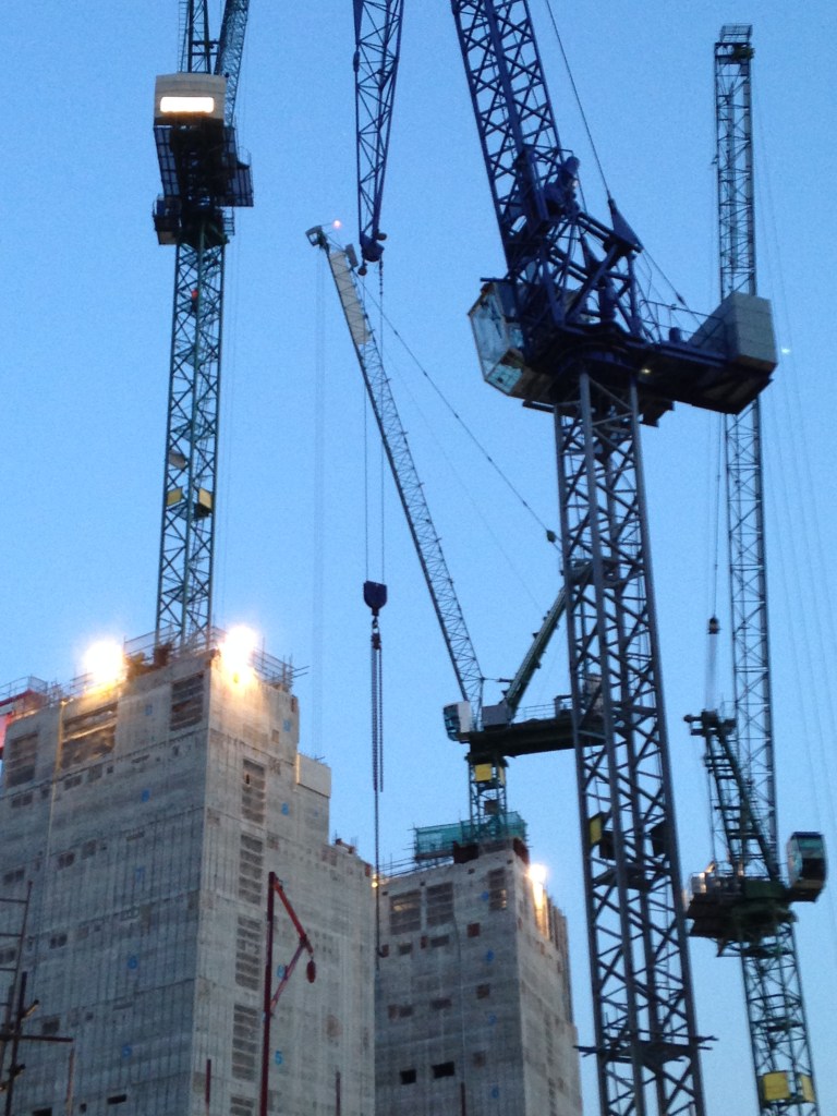 Vertical steel crane stretch above a concrete structure