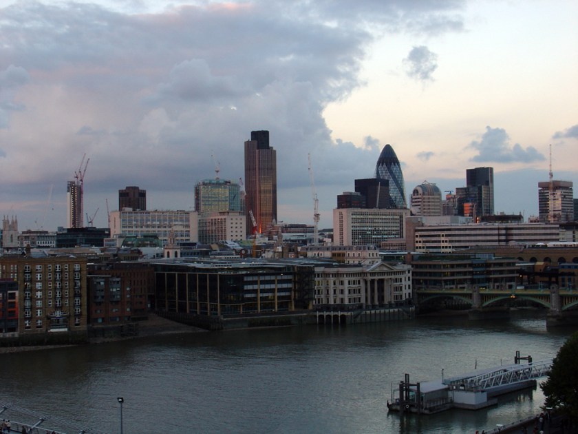 London riverscape with tall buildings including the Gherkin in the distance
