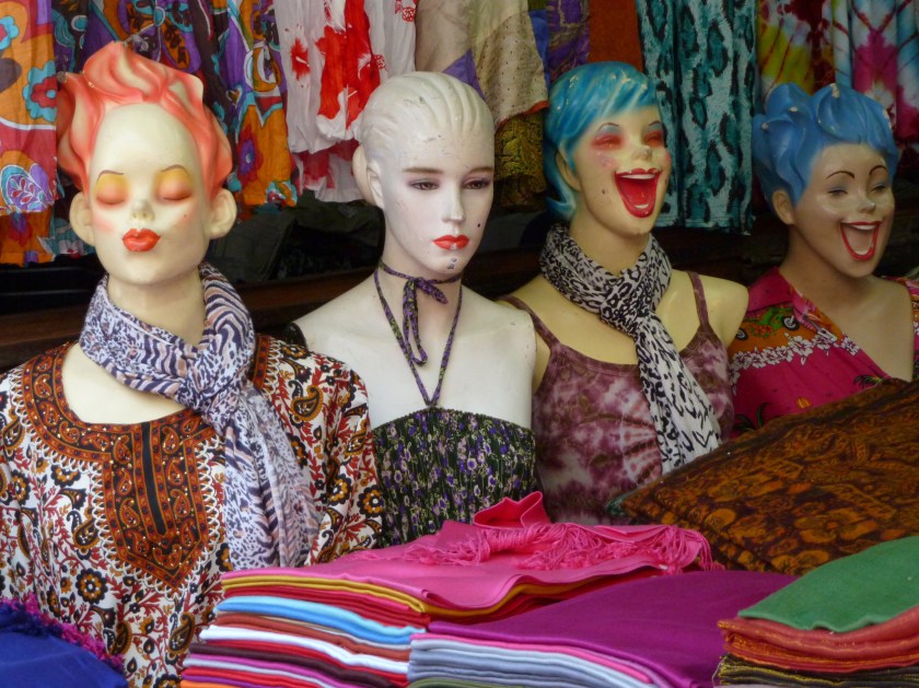 Colourful mannequin busts with big smiles model bright fashions