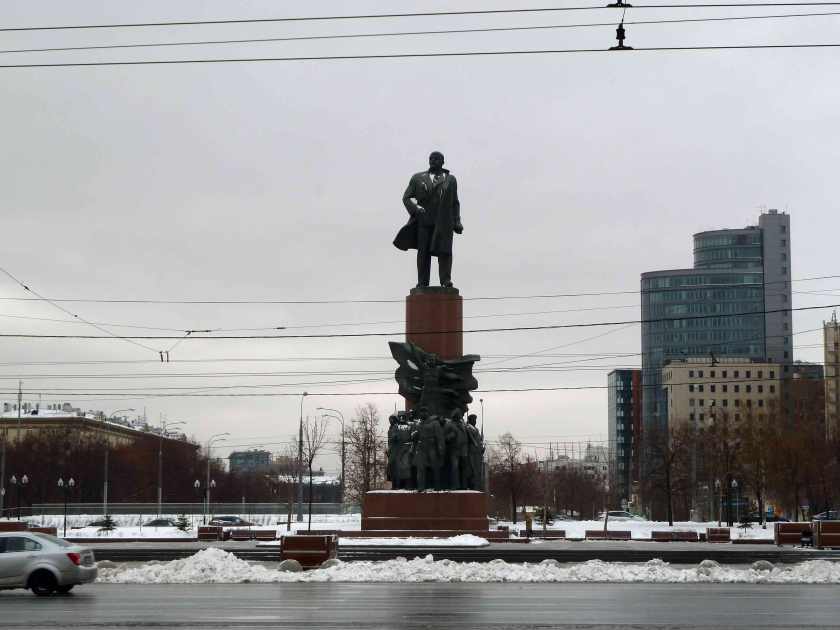 Bronze statue of Lenin over a busy street