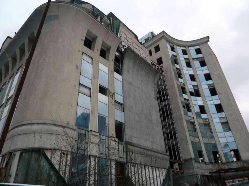 Absndoned concrete Soviet era office building with smashed windows