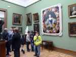Boy standing in front of paintings at State Tretyakov Gallery