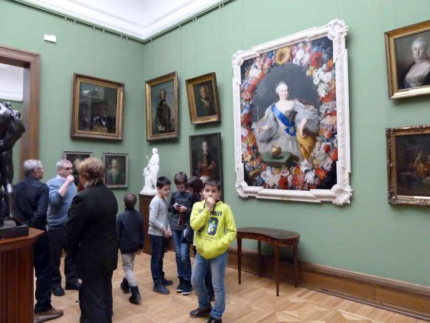 Boy standing in front of paintings at State Tretyakov Gallery