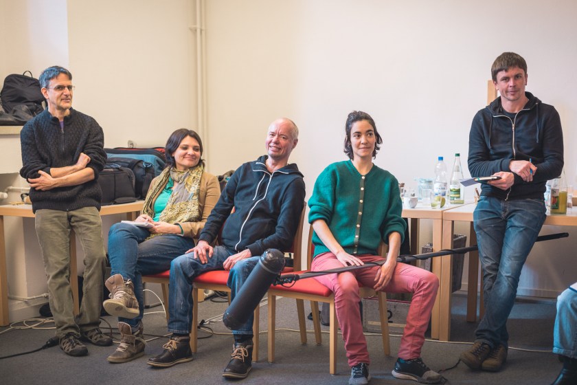 Director Michael Achtman with participating filmmakers, one holding a boom mic