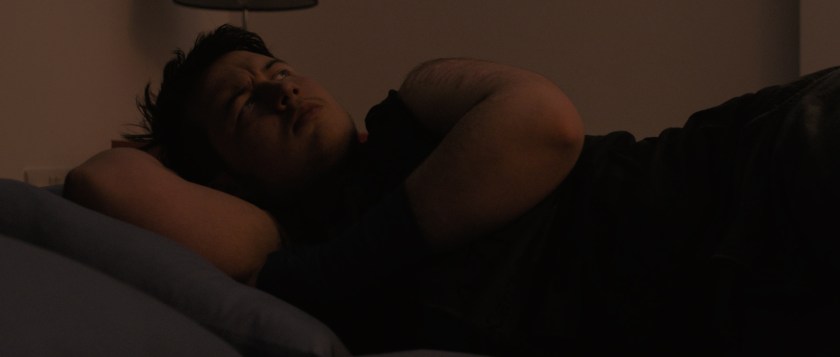 Orin looks up from their bed