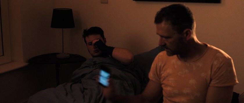Anto sits on Orin's bed with his phone