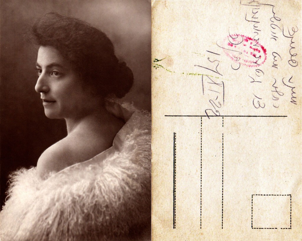 Sepia studio portrait of a woman turning over her shoulder in a feathered wrap, shown beside the postcard reverse with a handwritten Yiddish inscription.